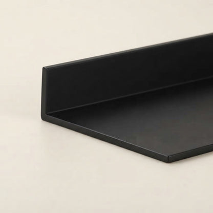 Black floating shelf underside with smooth edge and recessed mounting channel.