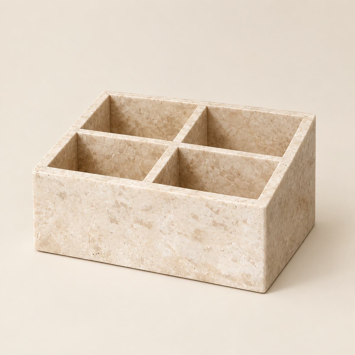 Travertine-style makeup organizer with four square compartments, light beige stone look.