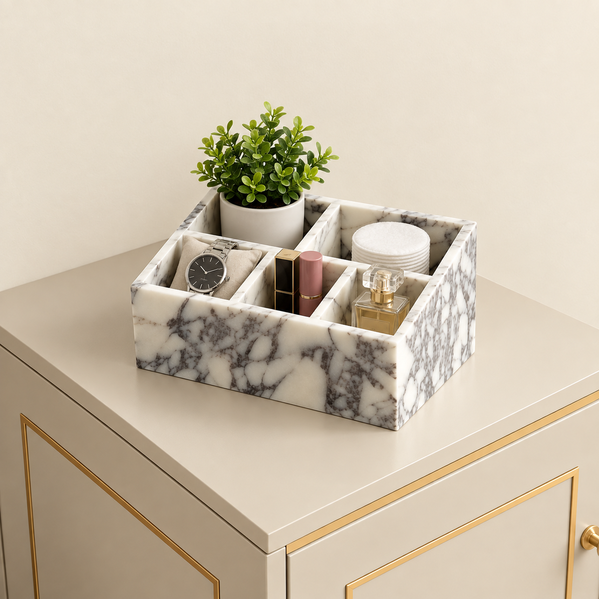 Calacatta marble makeup organiser tray with dividers, holding cosmetics and small jars.