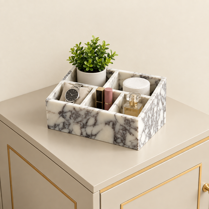 Calacatta marble makeup organiser tray with dividers, holding cosmetics and small jars.