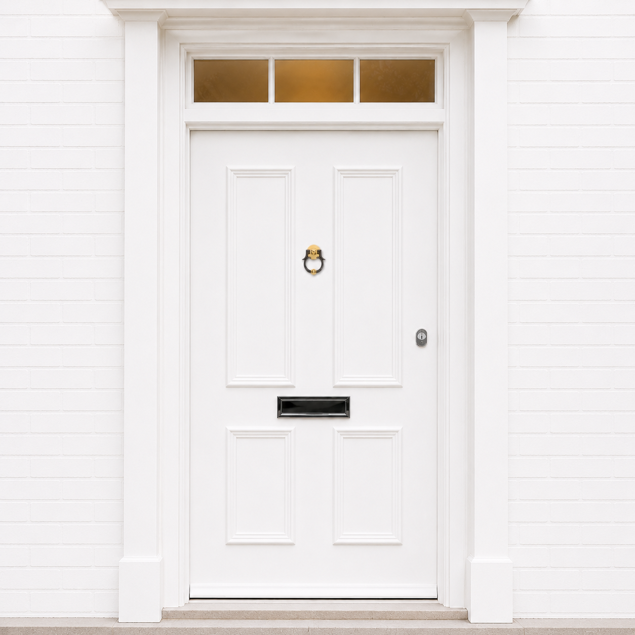 Brass and dark ring door knocker centered on a white front door