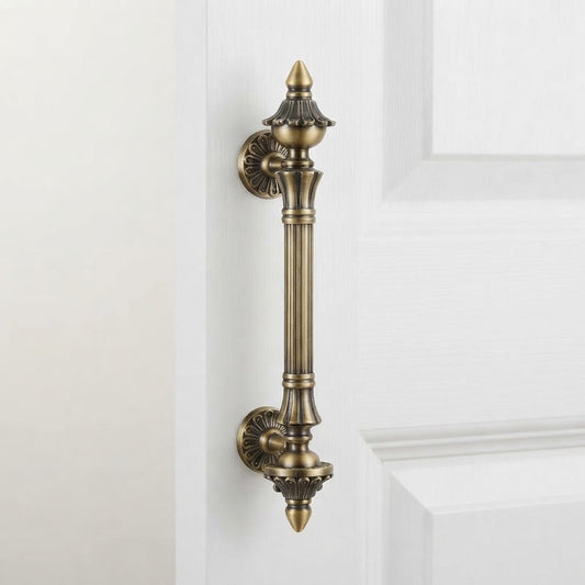 Antique brass fluted finial door pull handle with ornate circular backplates.