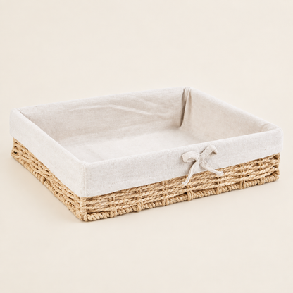 Woven willow straw storage basket with beige fabric liner and light straw sides