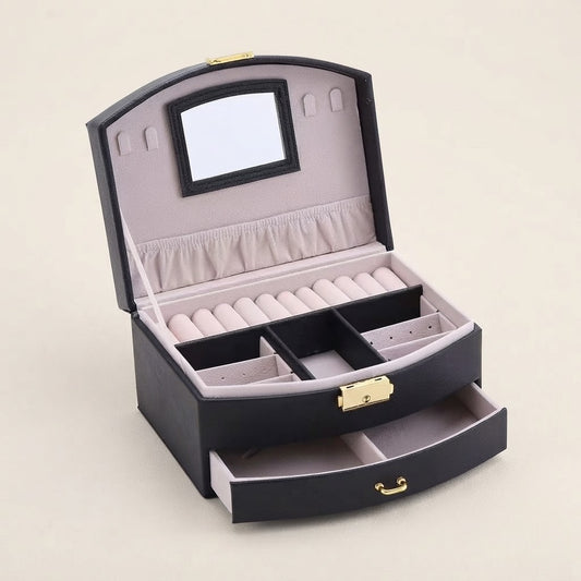 Black faux leather lockable jewelry box with open lid and necklace pad compartments