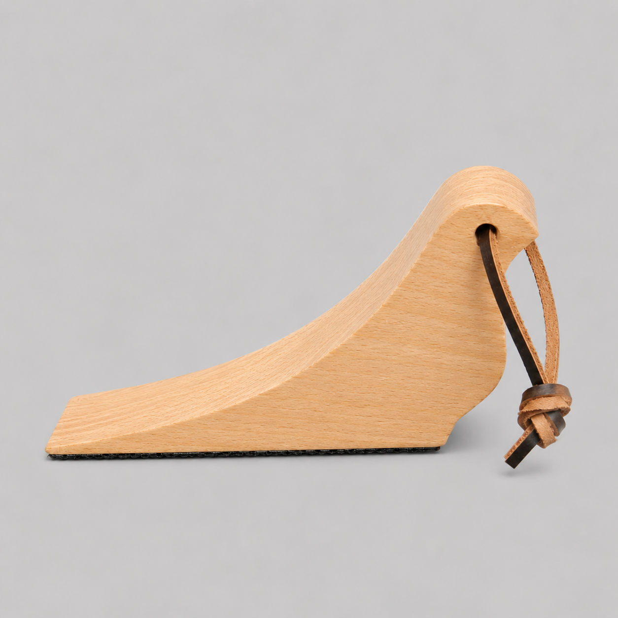Light beech wooden bird-shaped door stop with rope loop detail