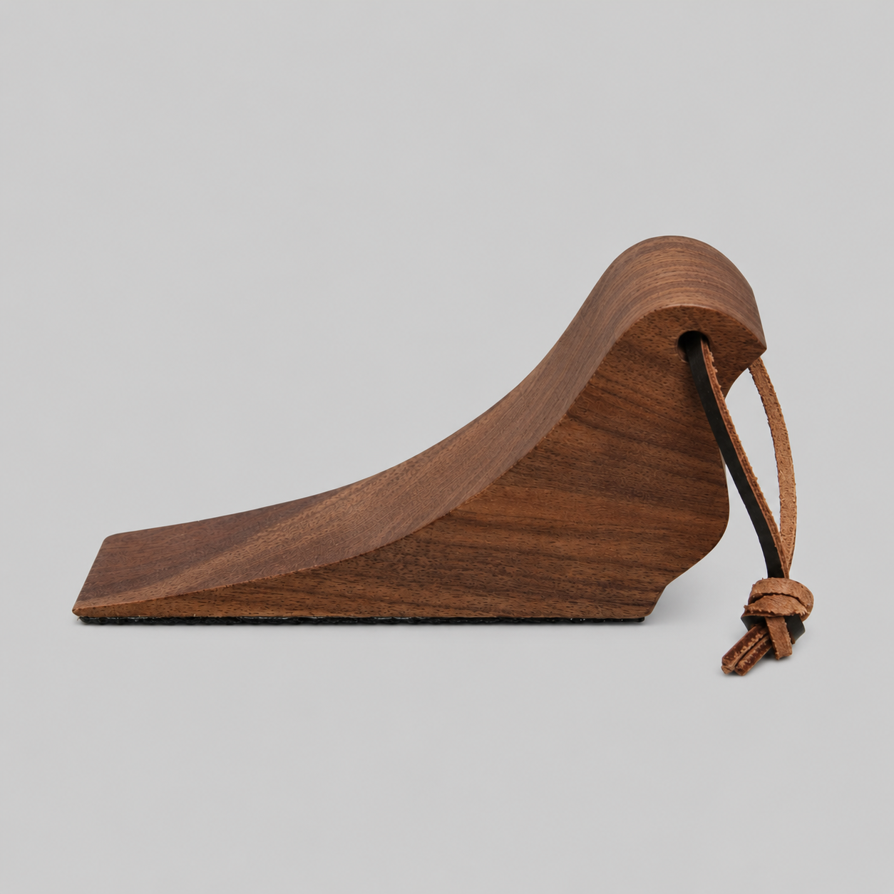 Walnut wooden bird-shaped door stop with rope loop detail