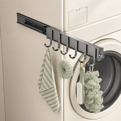 Dark sliding hook rail on side wall with curved hooks holding bath accessories