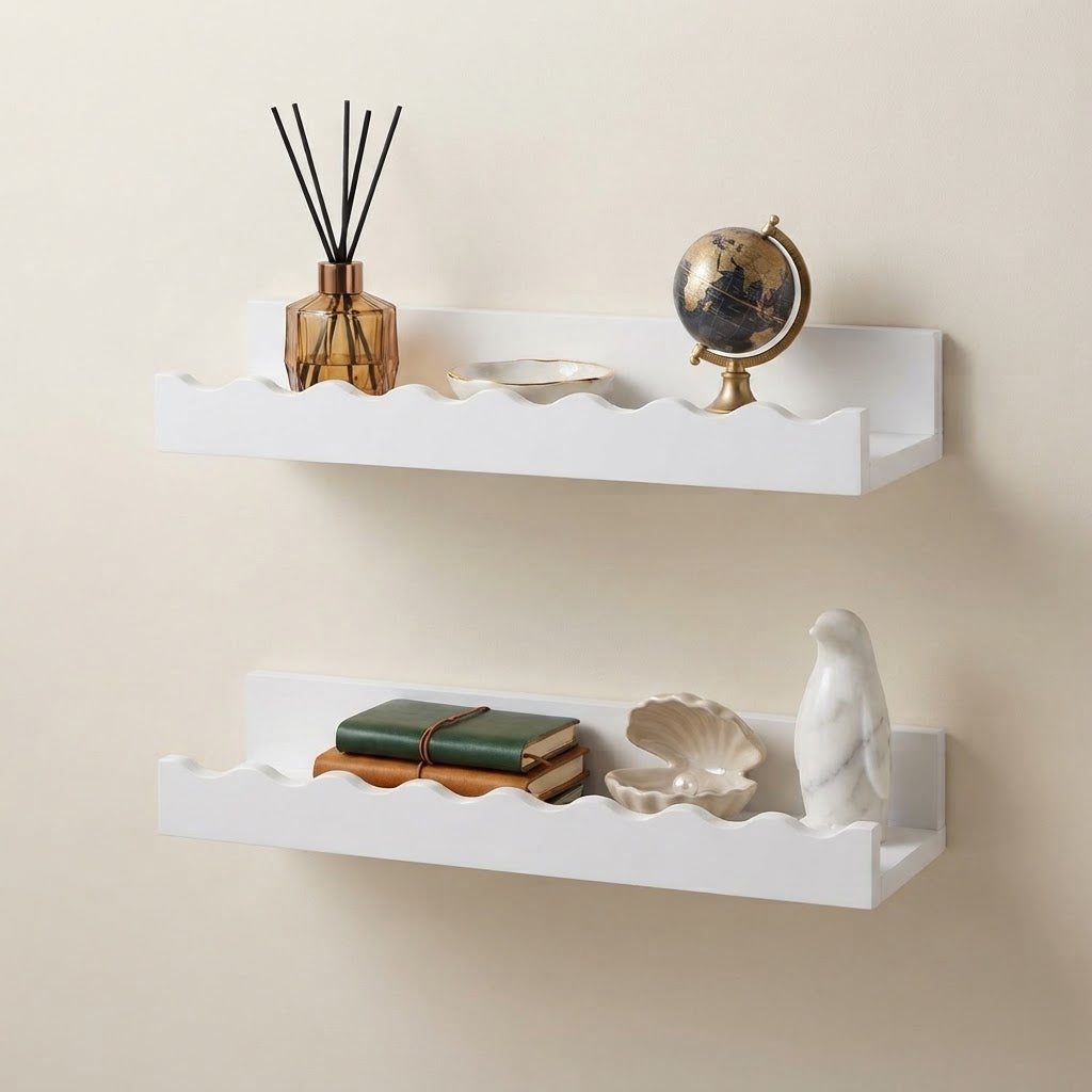 White wooden floating wall shelves with scalloped edges, styled with books and globe