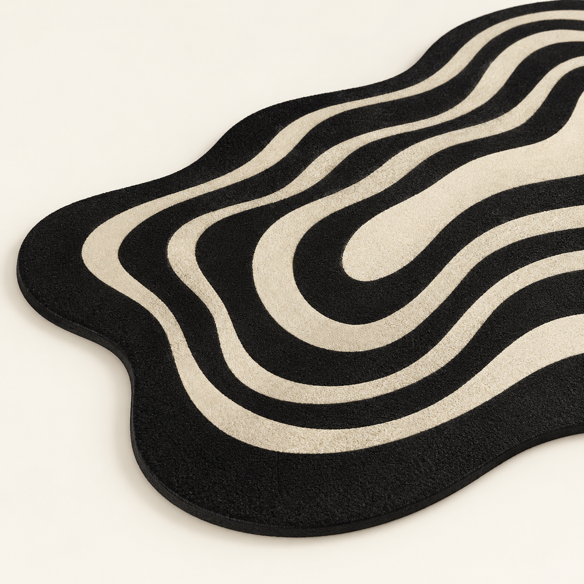 Close-up of black and beige wavy ripple non-slip bath mat texture and edging