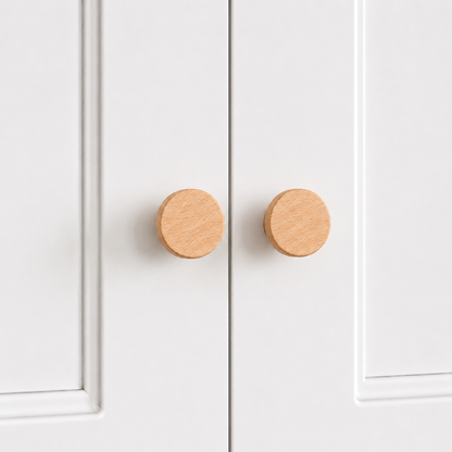 Light wood flared drawer knobs, round face with short pedestal, two shown
