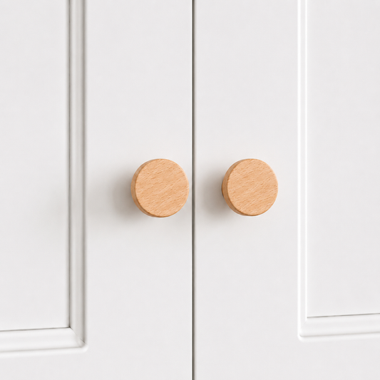 Light wood flared drawer knobs, round face with short pedestal, two shown