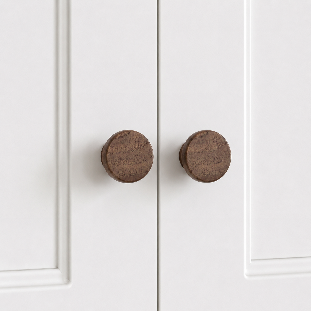 Dark wood flared drawer knobs, round face on short pedestal, two shown