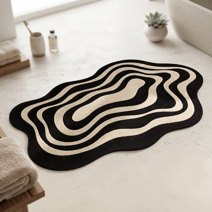 Black and beige wavy ripple non-slip bath mat laid on bathroom floor