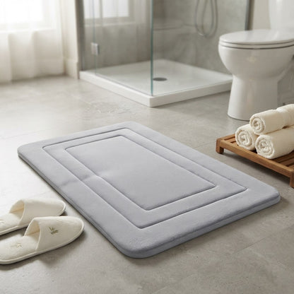 Light grey cushioned non-slip bath mat with recessed square and raised edges