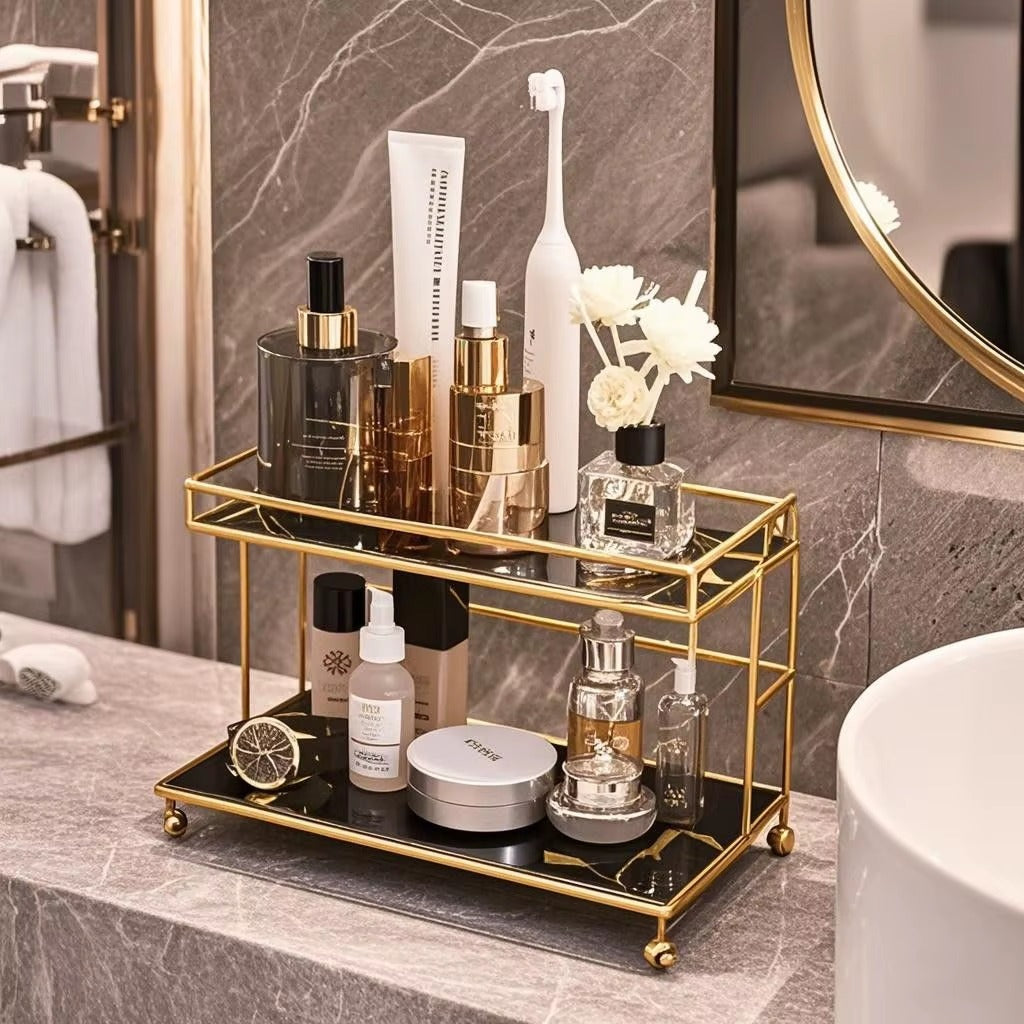 2-tier bathroom organizer with gold frame holding skincare bottles and jars on trays
