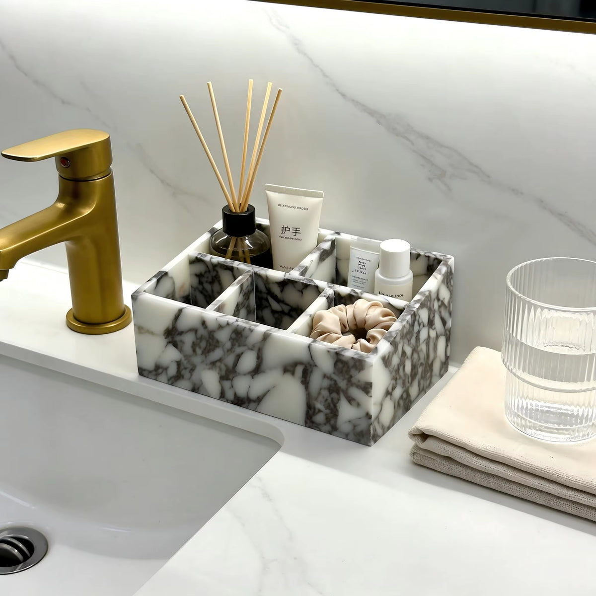 Marble makeup organiser with multiple wells beside toiletries on a bathroom counter.