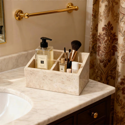 Travertine-style makeup organizer with four sections holding skincare bottles and brushes.