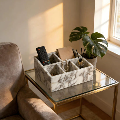 Calacatta marble organiser with compartments holding remote, cards, and a reed diffuser.