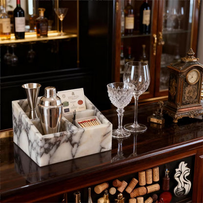 Marble makeup organiser with split sections holding grooming tools on a tabletop.