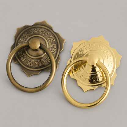Pair of brass pull ring door knockers in bronze and gold with ornate rosettes