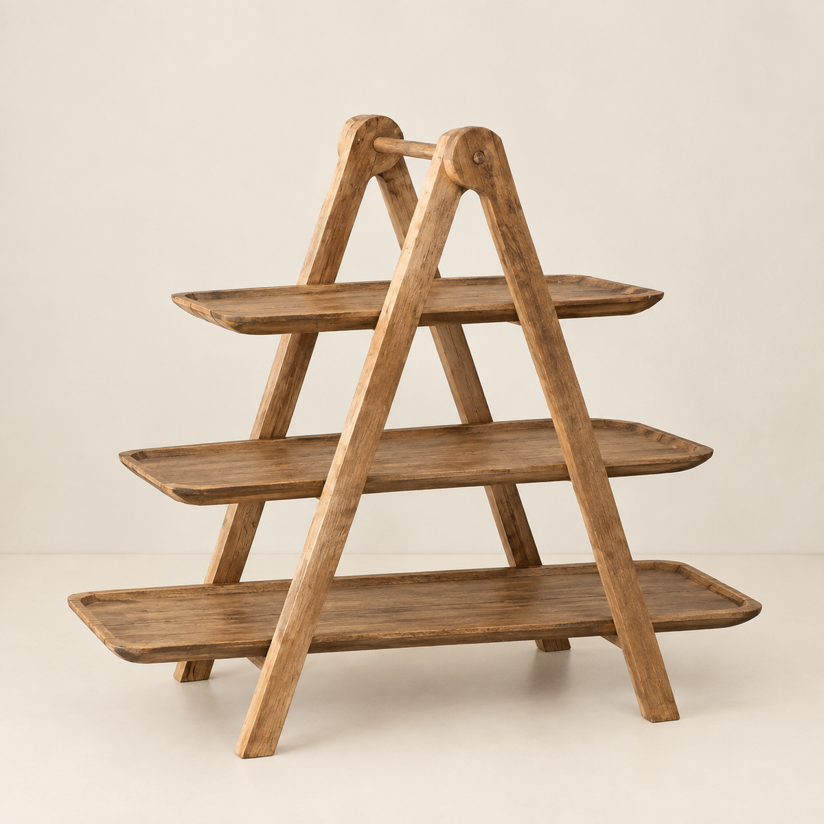 Three-tier wooden rack with angled legs and wide shelf boards