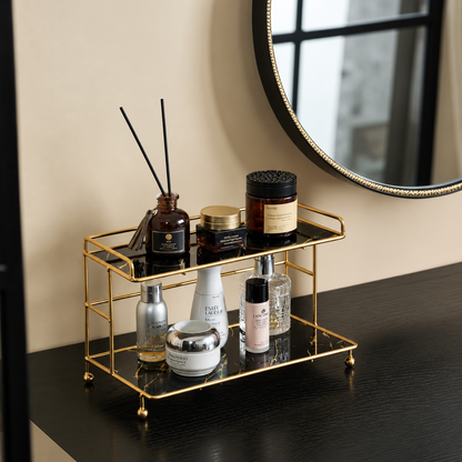 2-tier bathroom organizer with gold frame holding bottles on white marble-look trays