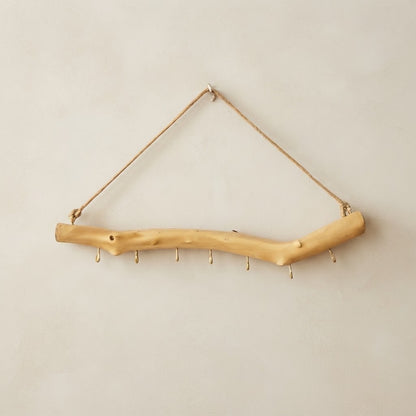 Light wood branch multi-hook rail with rope hanger and metal hooks along the curve