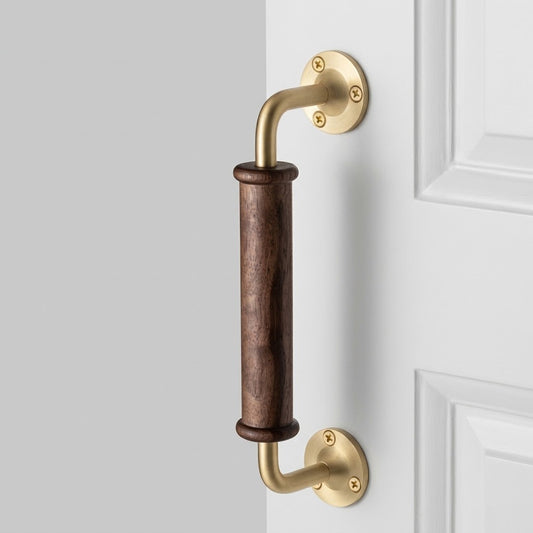 Walnut wood door pull handle with brass rose backplates and curved lever