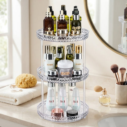 Three-tier rotating makeup organizer with clear acrylic tiers and mirrored diamond rim
