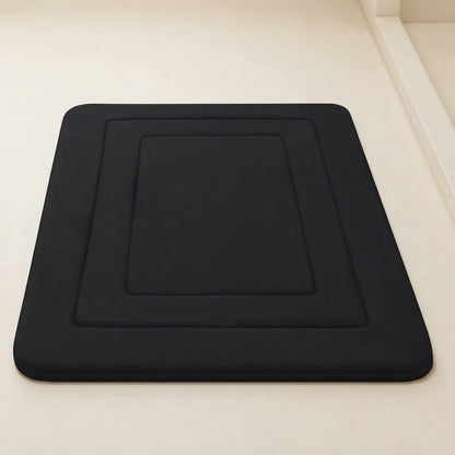 Black soft cushioned non-slip bath mat with recessed square design