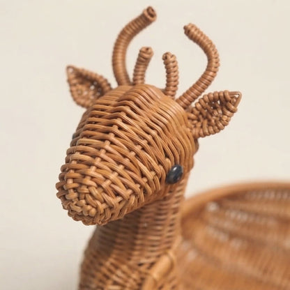 Close-up of woven bamboo animal storage basket head with small antlers and stitched eye