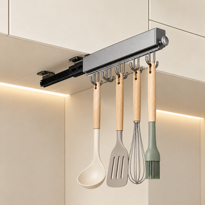 Grey under-cabinet pull-out sliding hook rail with hooks holding kitchen utensils