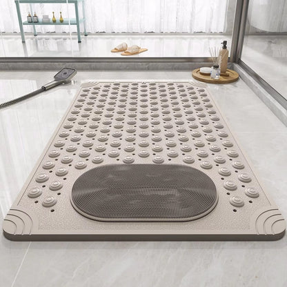 Non-slip shower mat with foot scrubber, light grey textured bumps and oval mesh pad
