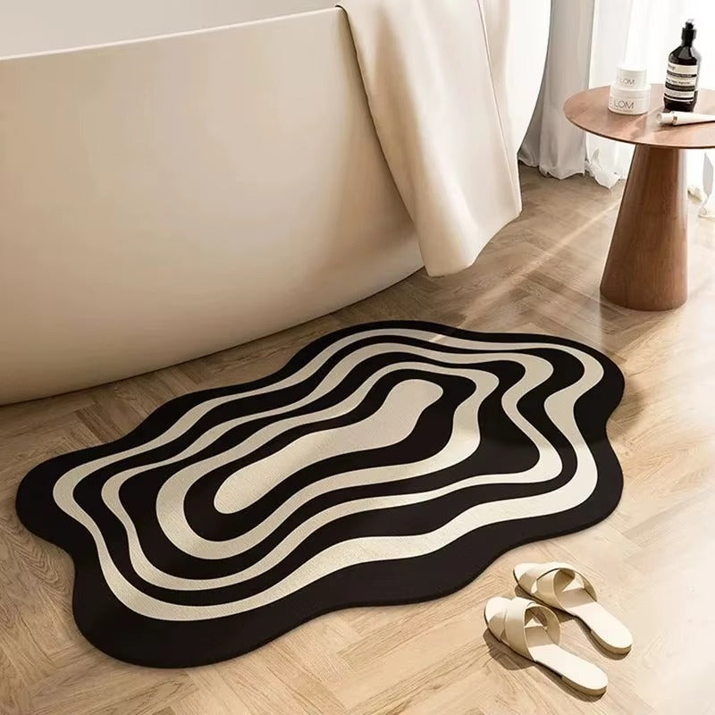 Black and beige wavy ripple non-slip bath mat in front of bathtub and shoes