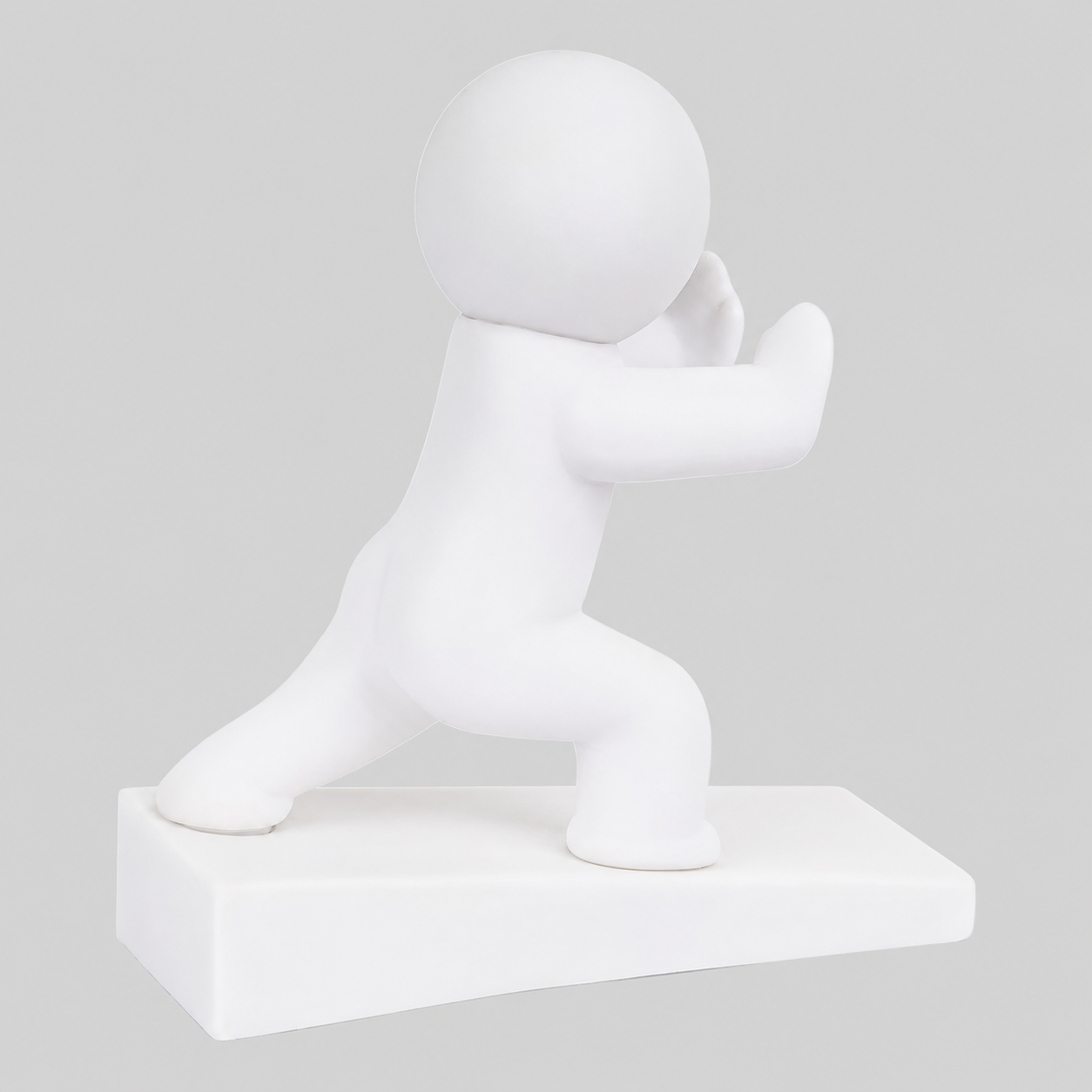 White playful character door stop in pushing pose, raised on a rectangular base