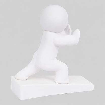 White playful character door stop in pushing pose, raised on a rectangular base