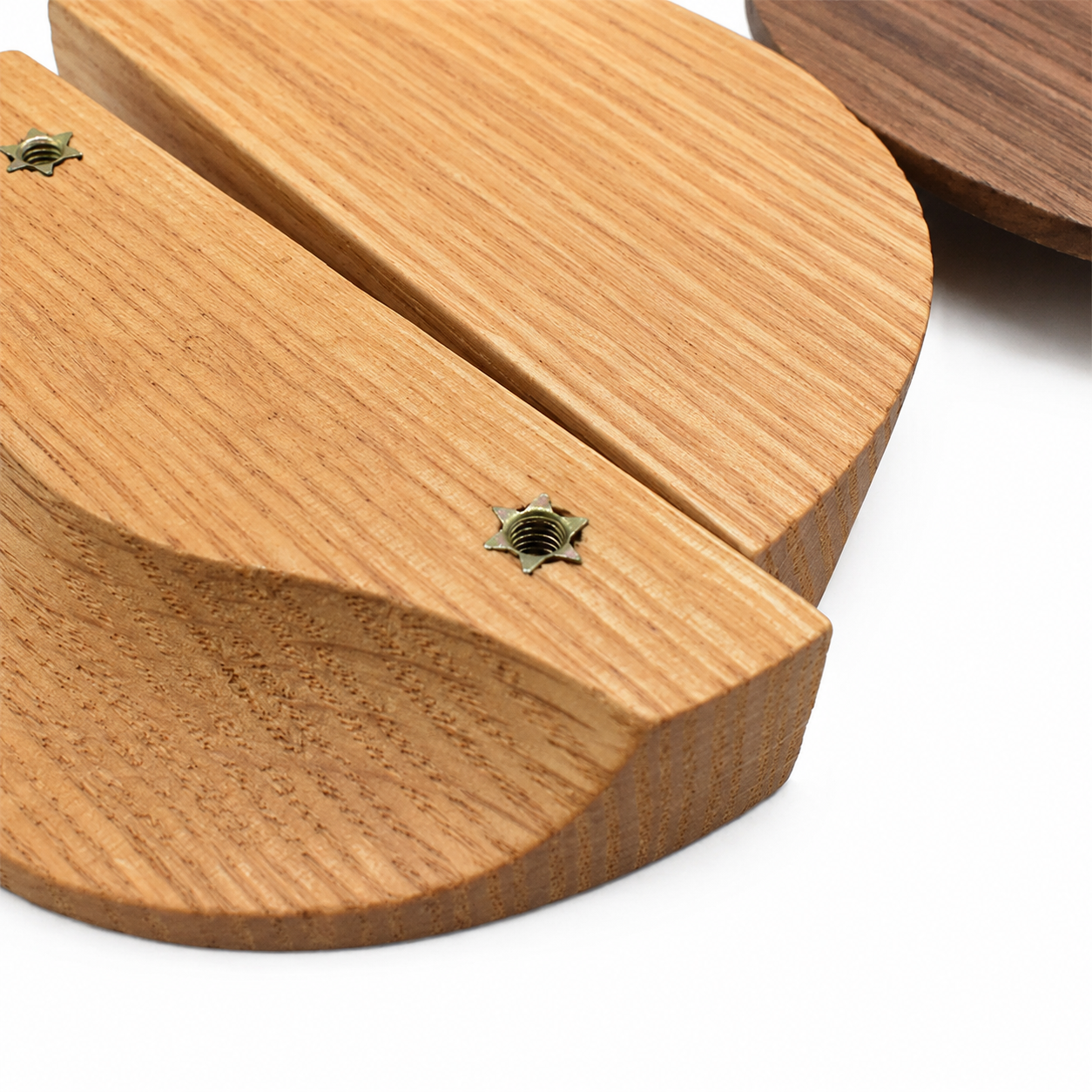 Wood semicircle cabinet pull handle with visible screws, textured grain, and split center