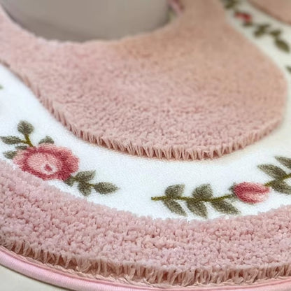 Pink floral bath mat corner detail with textured pile and fringe border