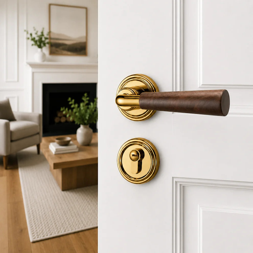 Interior door lock handle with dark wood lever and polished gold round rosettes