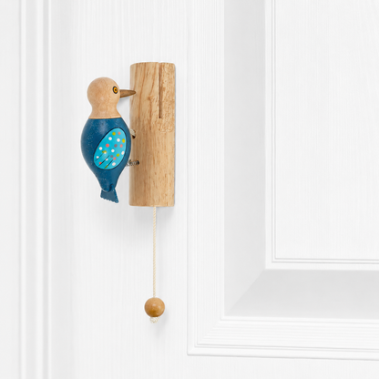 Woodpecker door knocker on wood backplate with blue speckled wings and dangling ball cord