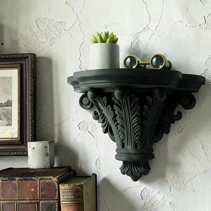 Black carved corbel floating shelf with scalloped underside and leaf medallion detail