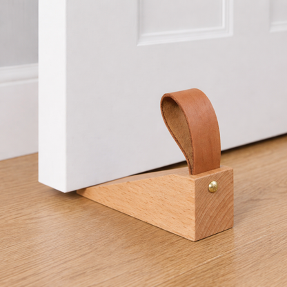 Tepora wooden wedge door stop, light beech wedge with tan rubber bumper and brass button