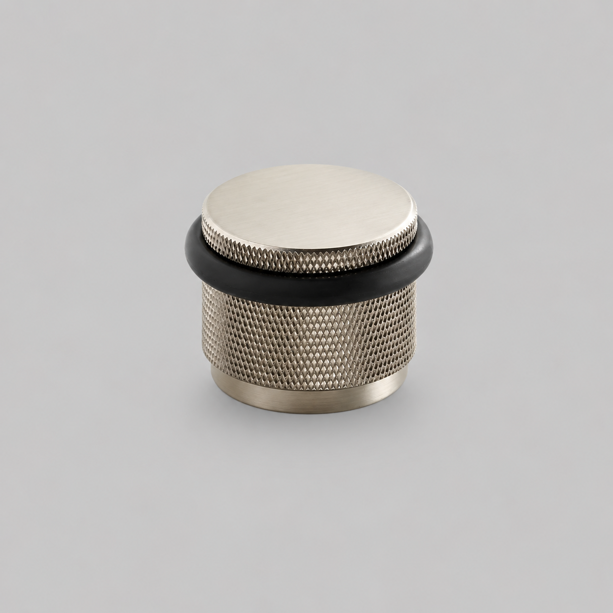 Brass knurled door stop with silver top and black rubber base ring