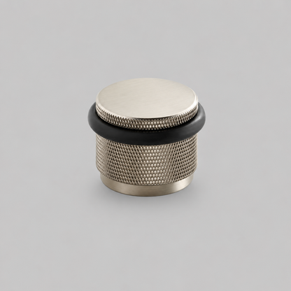Brass knurled door stop with silver top and black rubber base ring