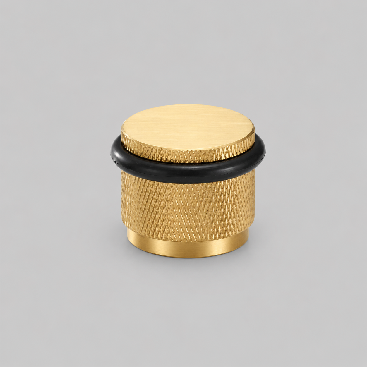 Brass knurled door stop with black rubber base ring and round top cap