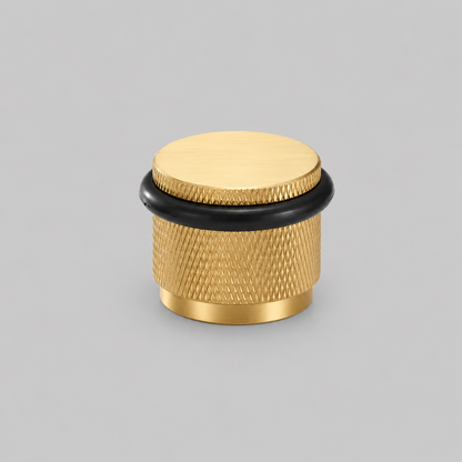 Brass knurled door stop with black rubber base ring and round top cap