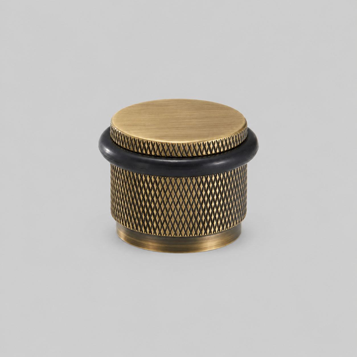 Brass knurled door stop with round wood-tone top cap and black rubber ring