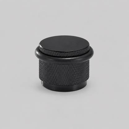 Black knurled door stop with round black top and black rubber base ring