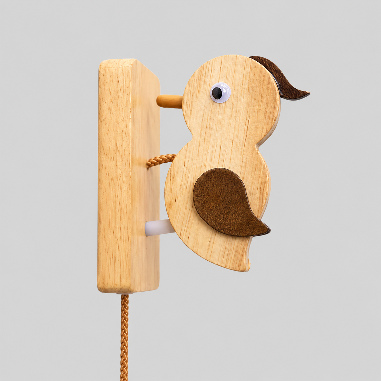 Wooden woodpecker door knocker with round metal eye and attached mounting board