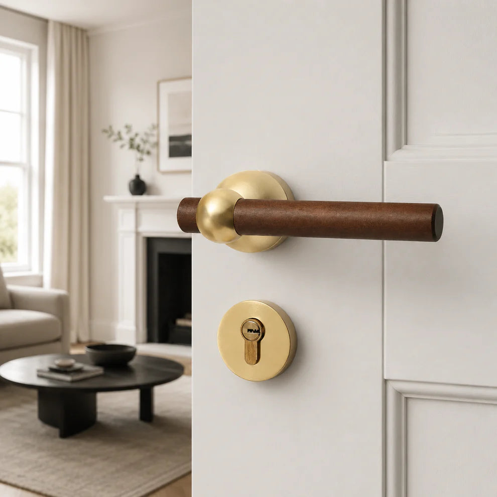Walnut door lock handle with gold lever and keyhole plate on white door
